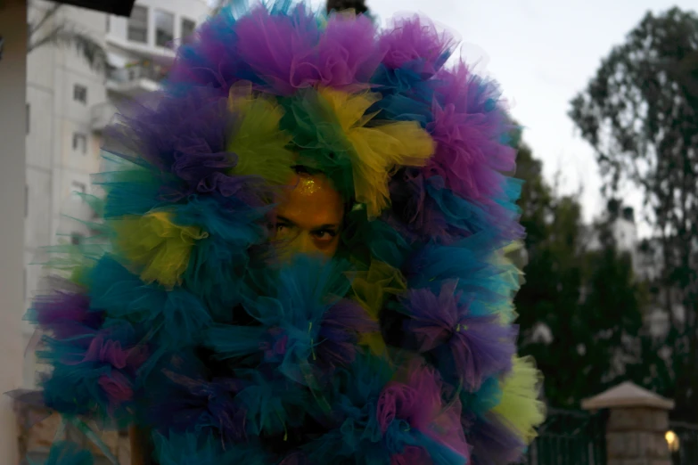 there is a man in a colorful suit standing on the street