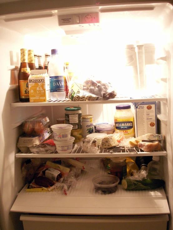 an open refrigerator with food all in it