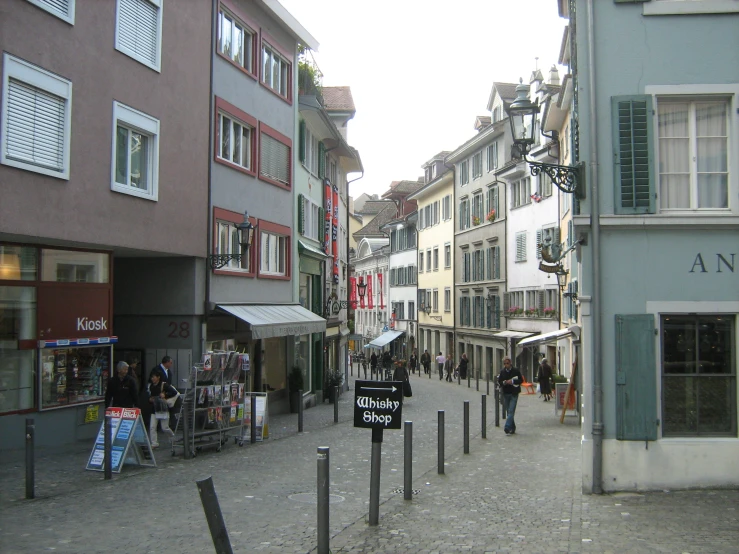 several people walking down a busy street in a foreign country