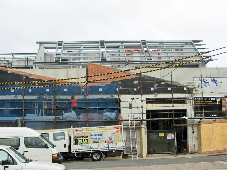 the front view of a building with construction equipment on top of it