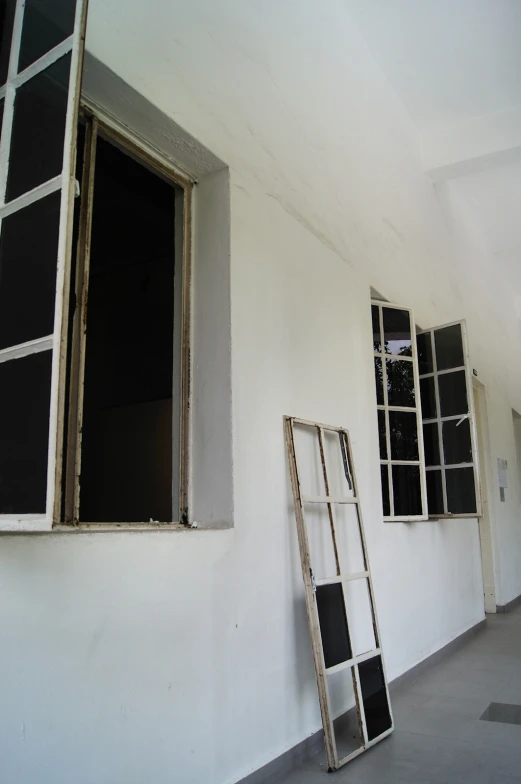 the window frame of an empty building near a ladder