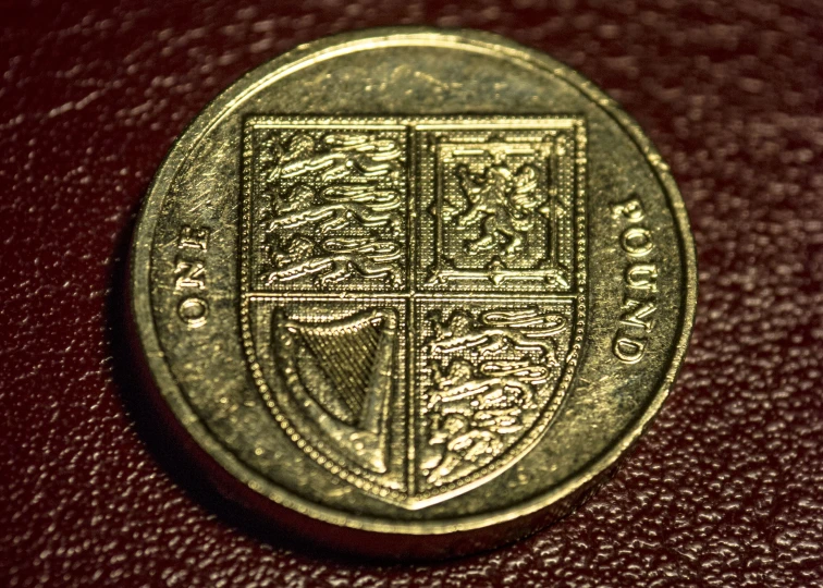 a gold coin sitting on top of a red table