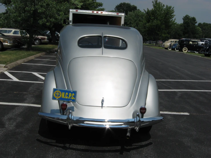 an old car is shown parked in a lot