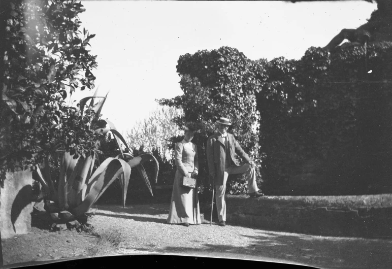 a man and a woman are standing outside a house