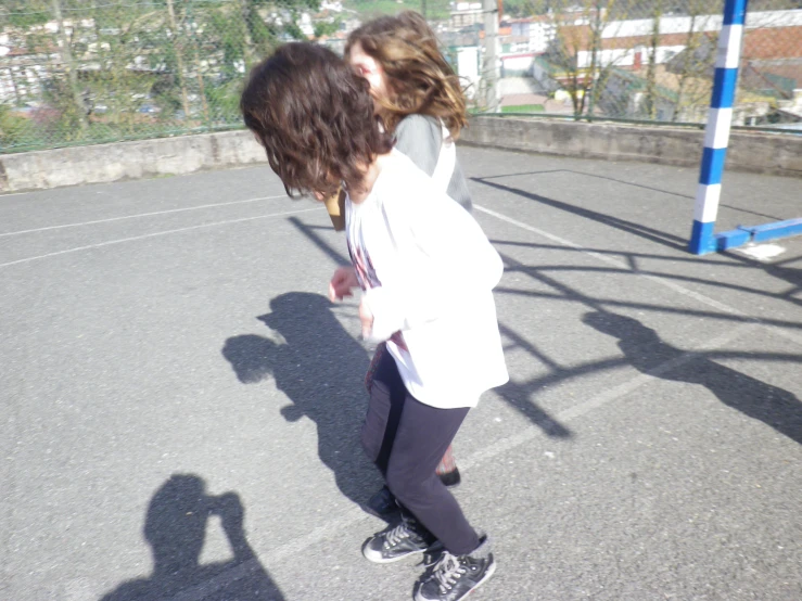 a girl and a boy kissing on a trampoline