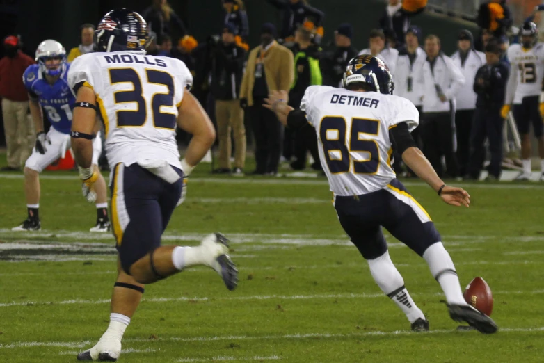 a football player is running with the ball