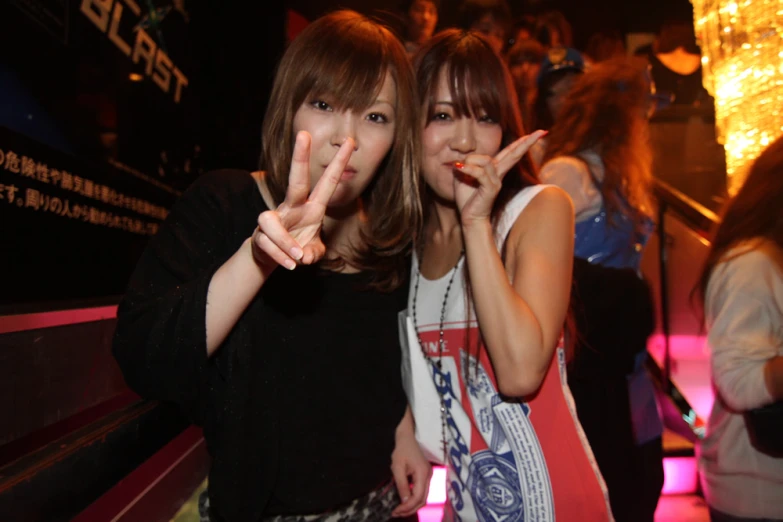 two women posing for a po at a party