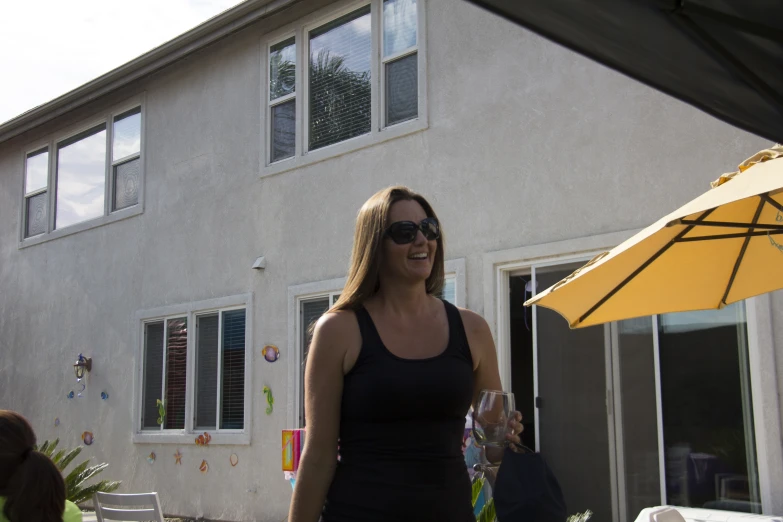 a woman walking around with an umbrella on her