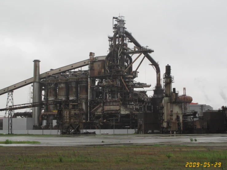 large machine building near the field in front of a factory