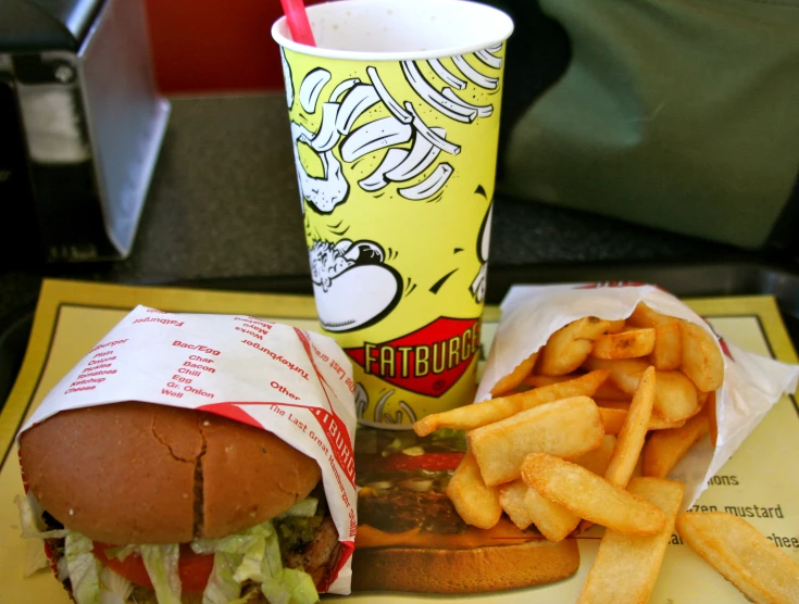 a sandwich and french fries are served on a tray