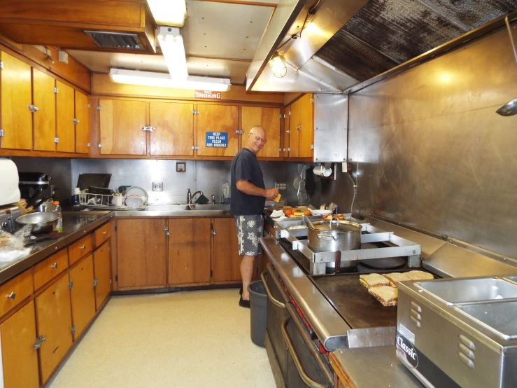 a man cooking in a kitchen that is very nice