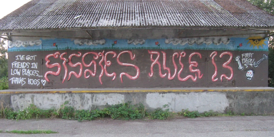 some graffiti on a building and a stop sign