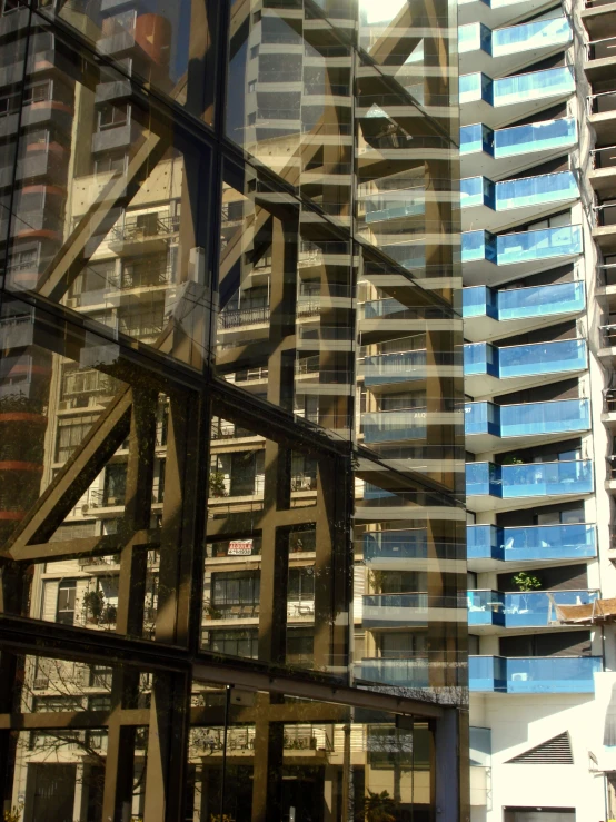 a group of windows and a large mirror reflecting the buildings