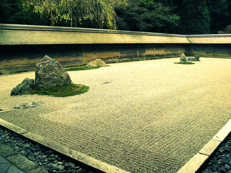 a stone courtyard and landscaping is shown in this picture