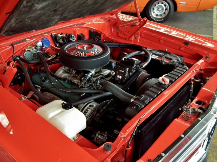 a engine in an orange colored sports utility vehicle