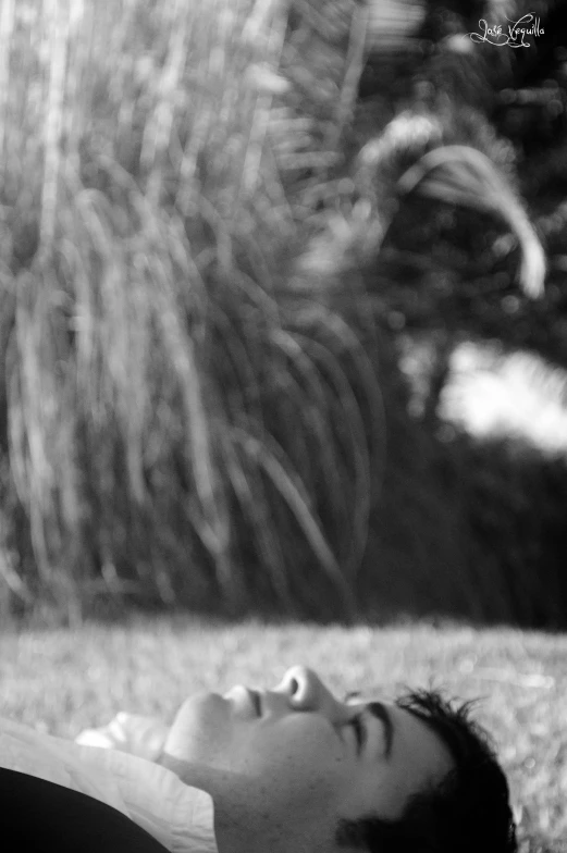 a man lays down next to a horse in the field