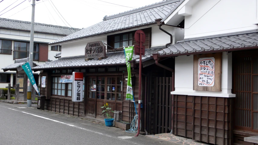 a street in a small japanese country town with wood fencing