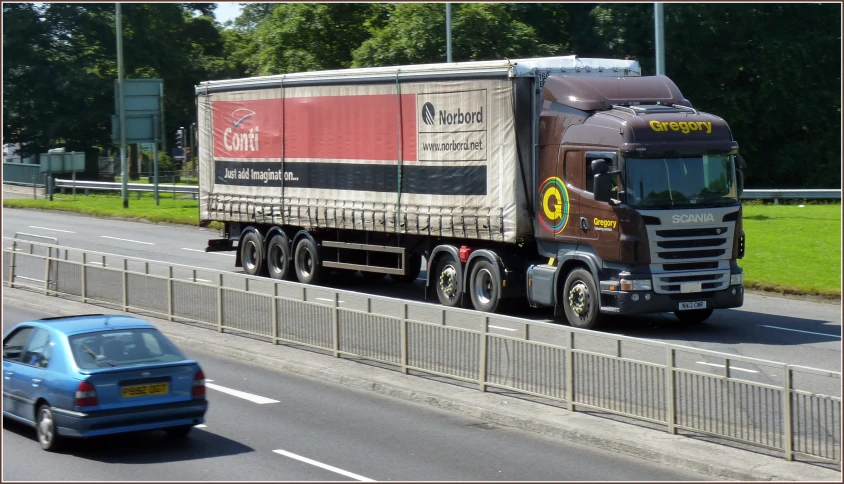 a truck carrying cargo drives down the road