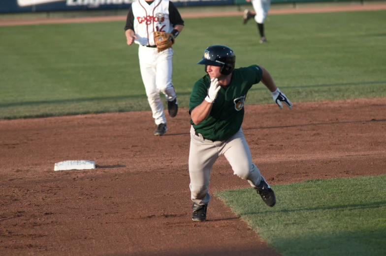 a couple of baseball players run for base