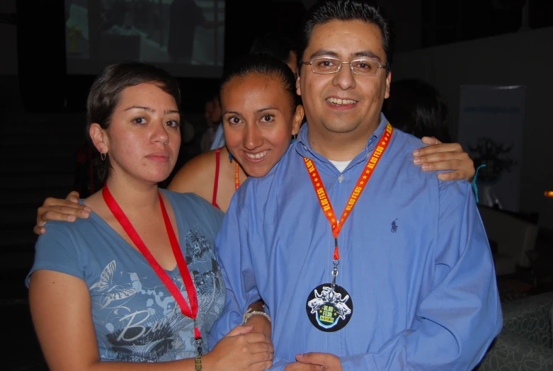 two women and one man are posing for a picture