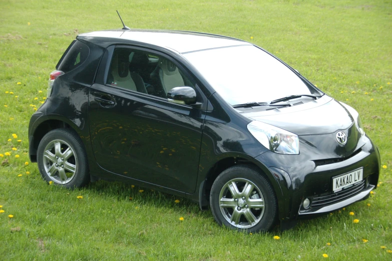 a small car sitting in the middle of the grass