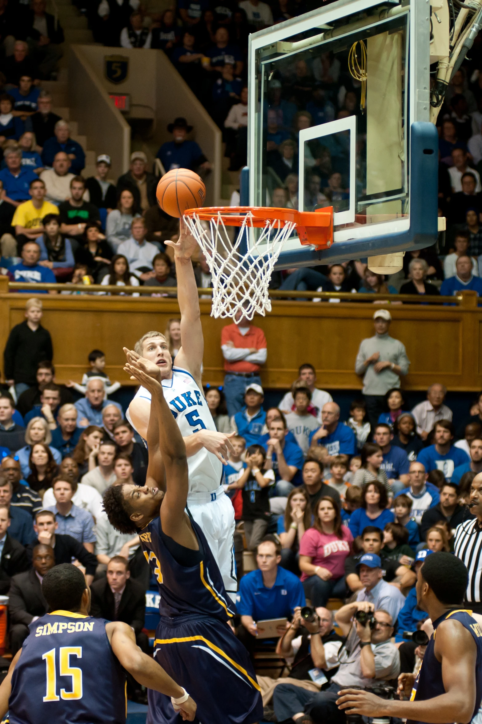 a group of men play basketball on the court