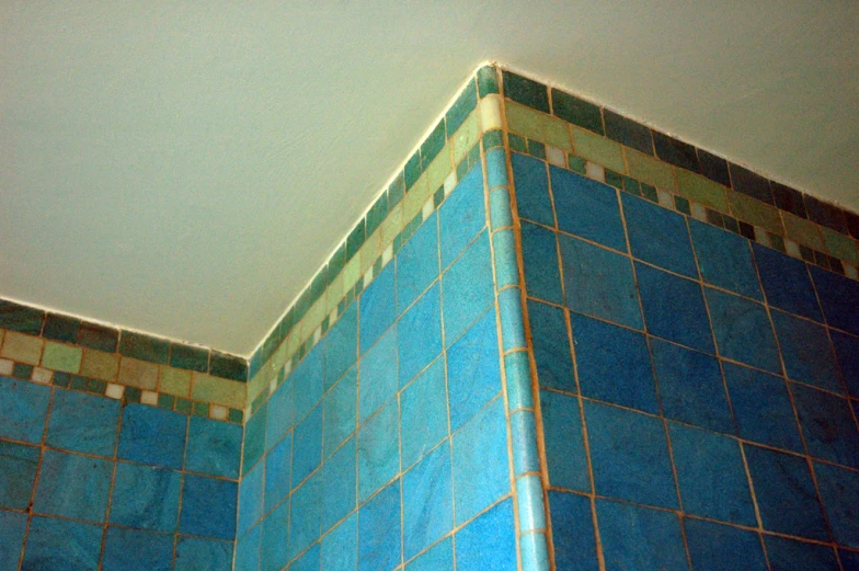 the top side of a blue tile building with a sky background