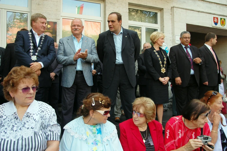 there is a man standing in front of several other people