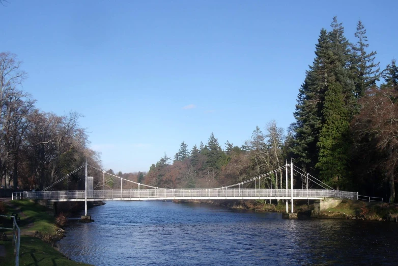 a white bridge crosses over a large river