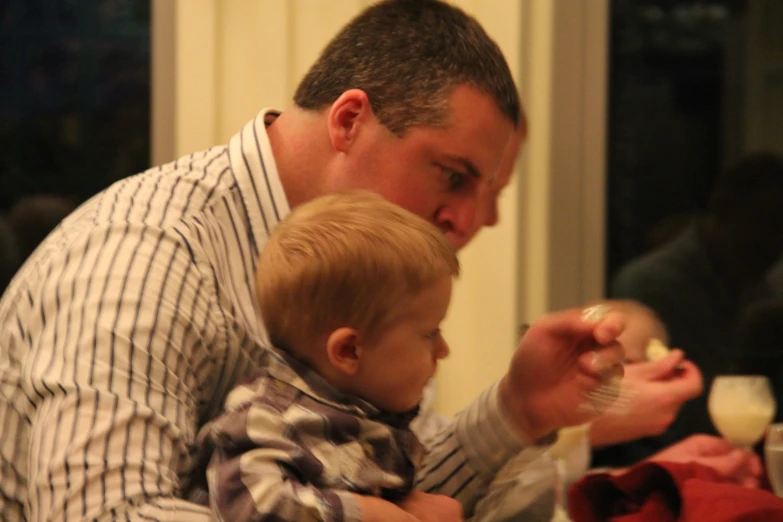 a man holding a toddler in his lap