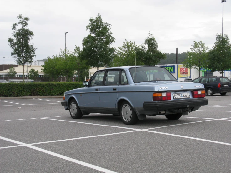 this is an old car sitting in a parking lot