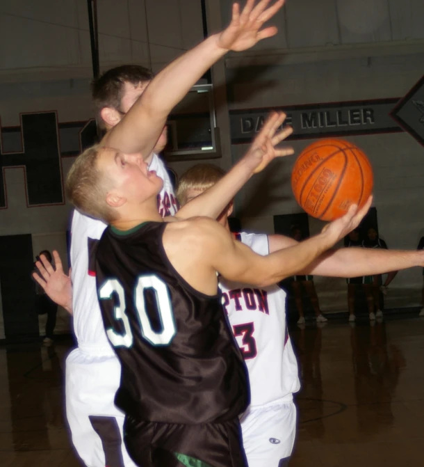 a group of men in uniforms on a basketball court