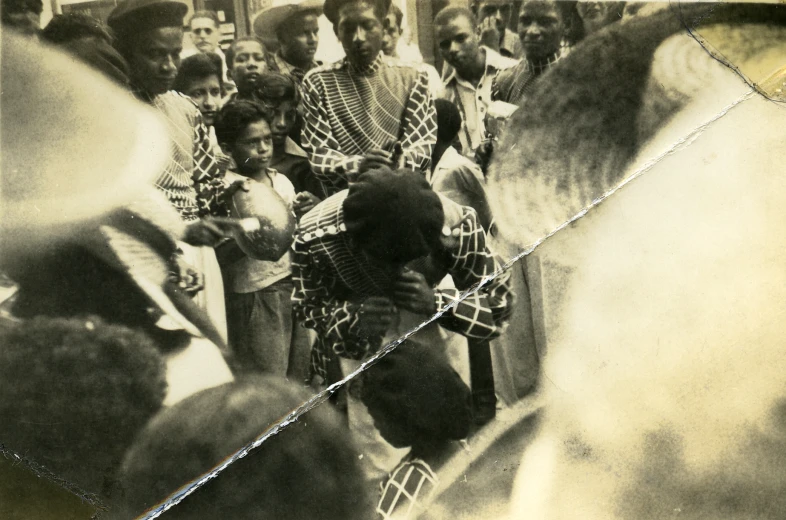 a woman in patterned coat walking down street with a crowd