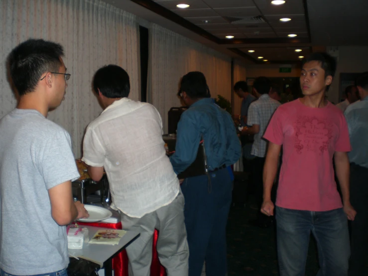 two men talking to each other and one standing