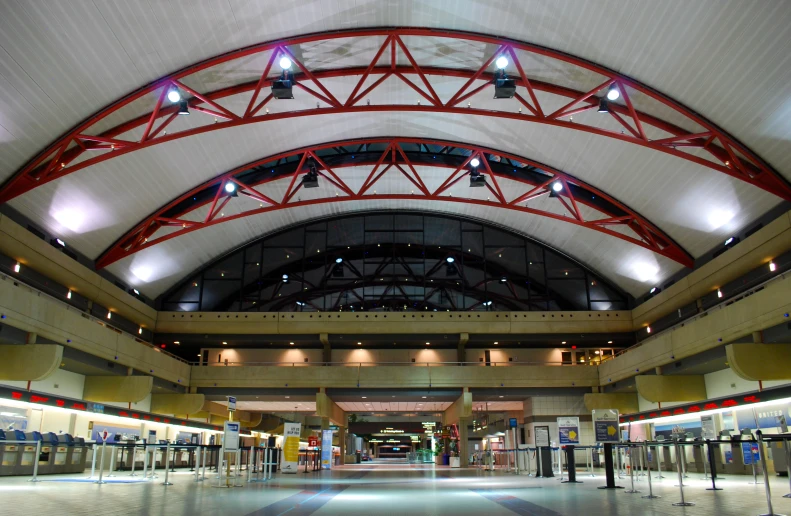 the inside of a large building with metal poles