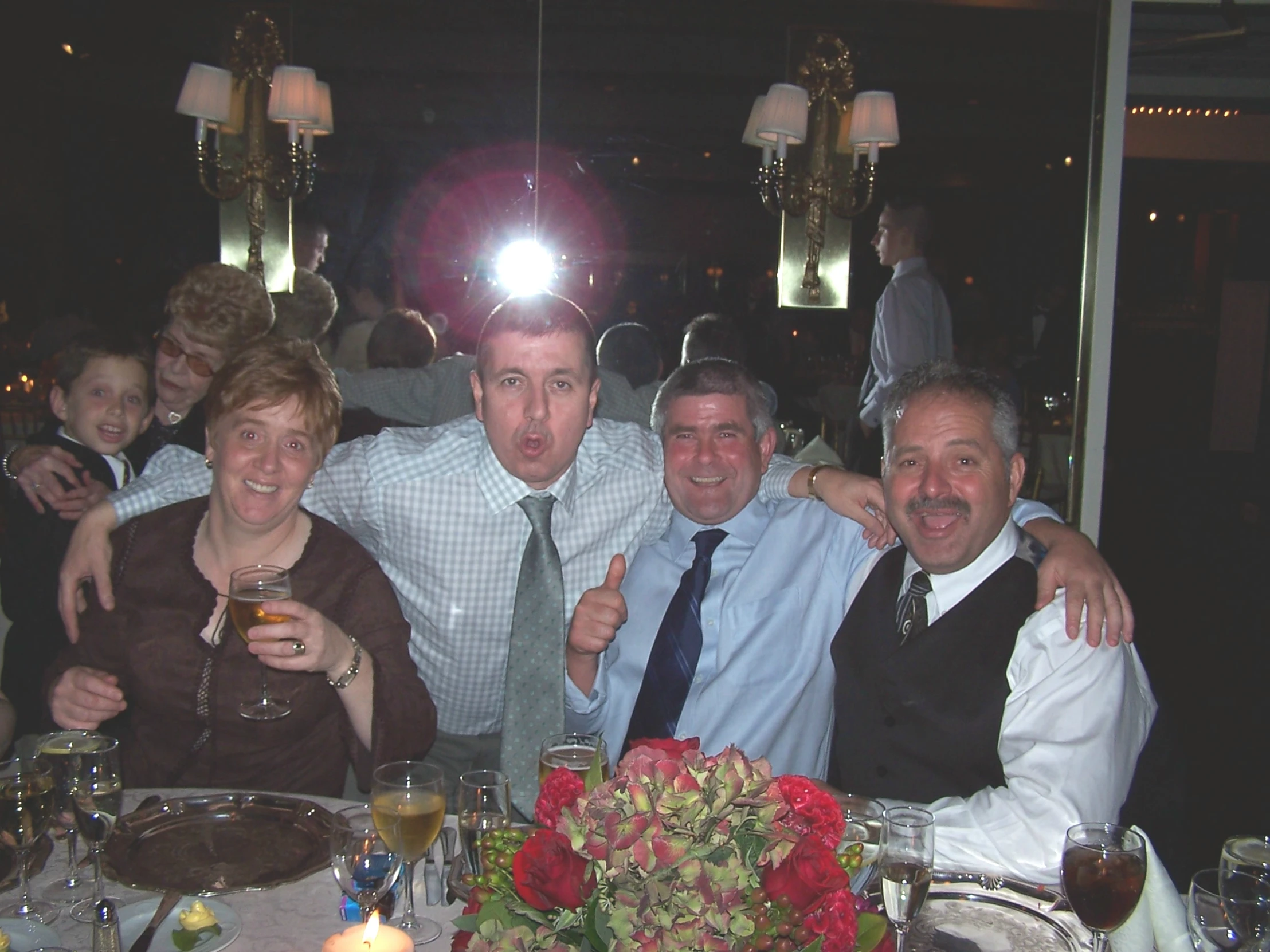 a group of people sitting at a table at night