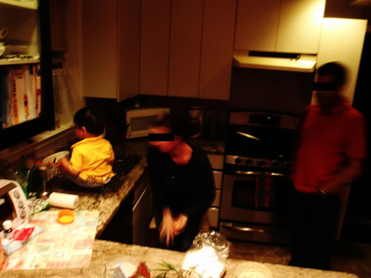 the people are standing in the kitchen preparing food
