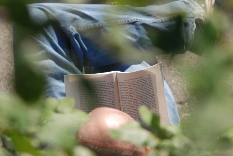 an open book sitting on top of a persons lap