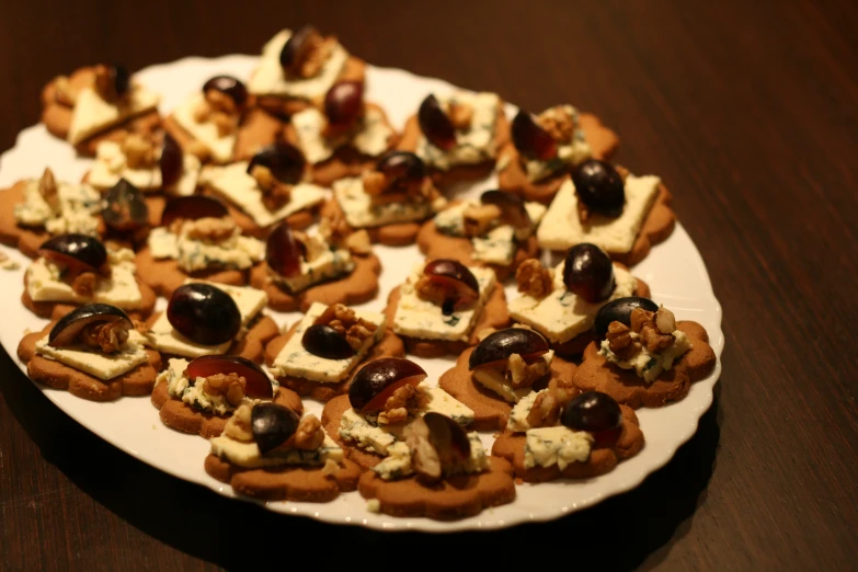 plate with a variety of small snacks and nuts