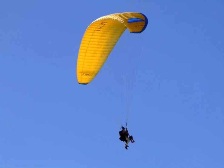 a person jumping high into the air while on a parachute