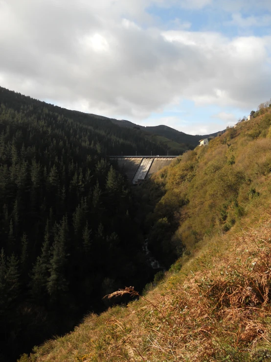 a view of the top of a hill overlooking a waterfall