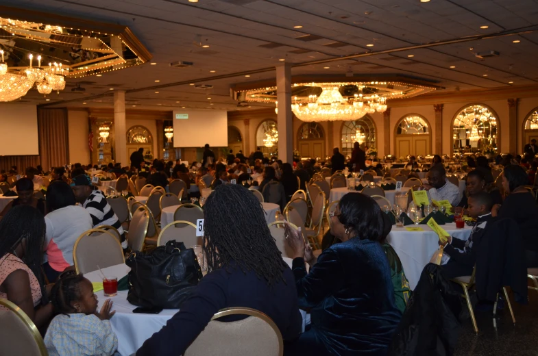 a very large group of people at tables