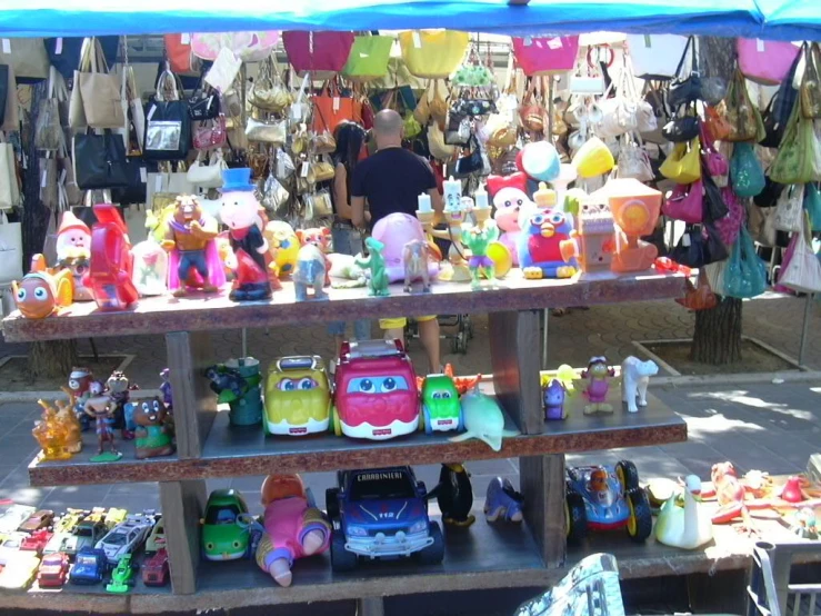 a person standing next to a display of toys for sale