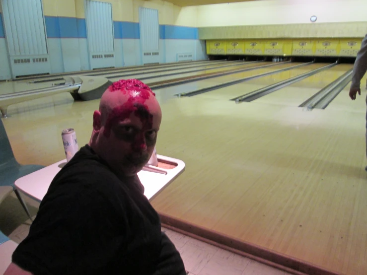 a man is in a bowling alley with y skin