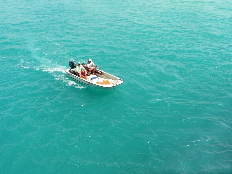 a small boat full of people in the ocean