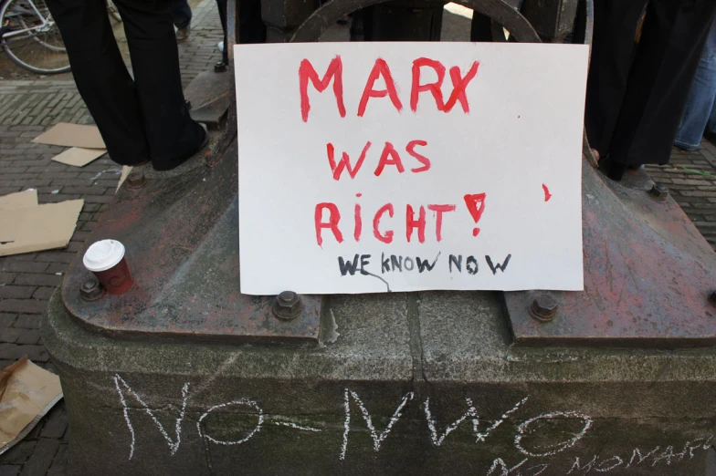 a protest sign that says marx was right we know now