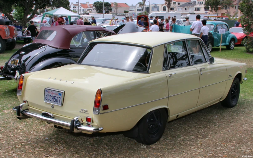 several vintage cars on display at a car show