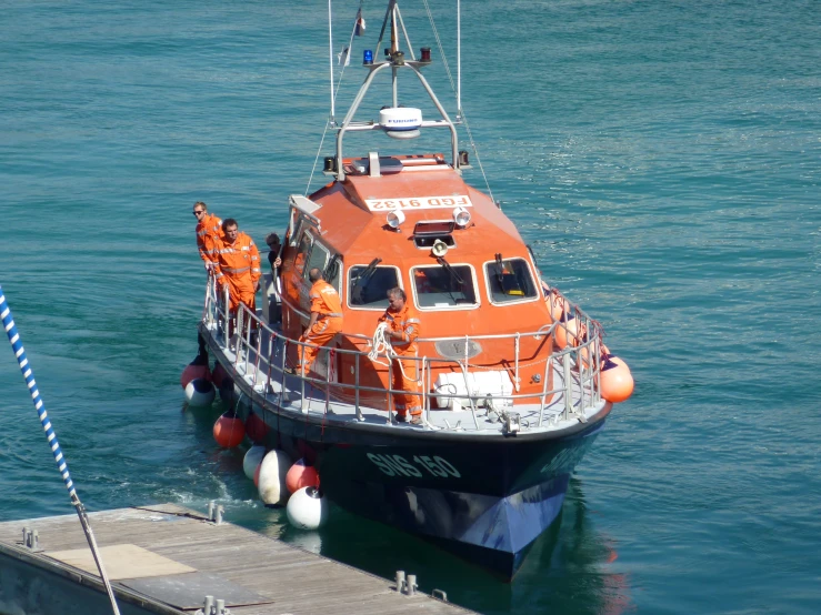 an orange coast guard boat in a body of water