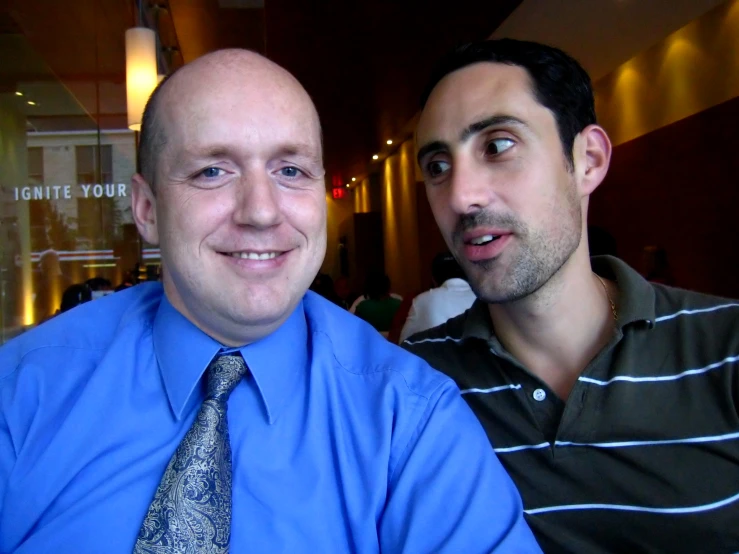 the two men are both wearing ties smiling