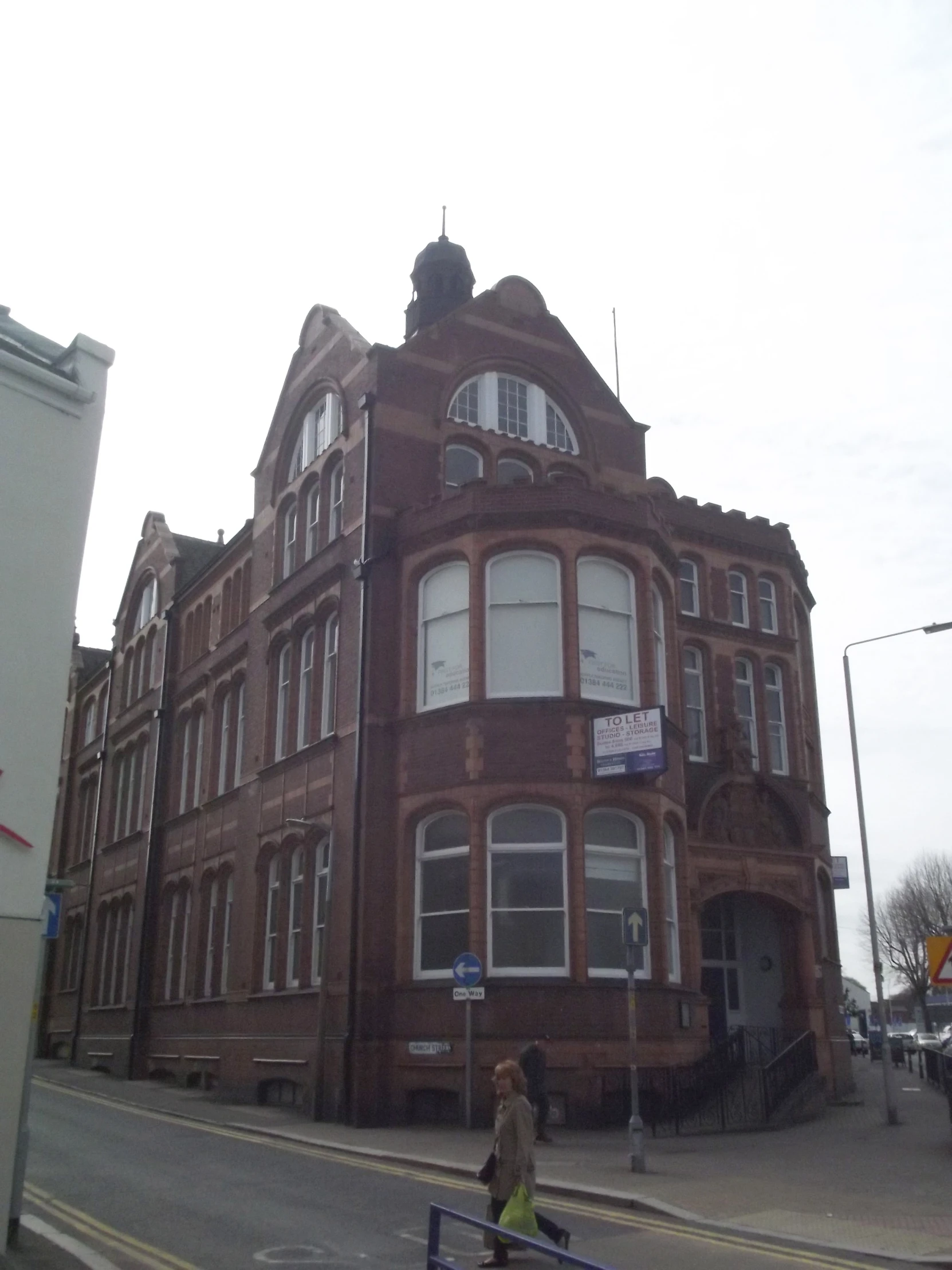 a large brick building is in the street